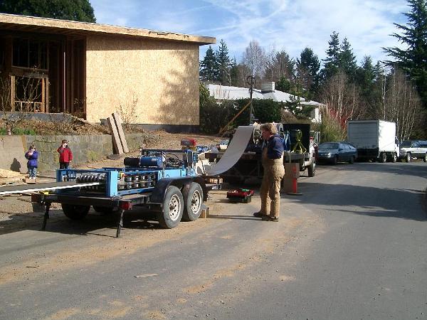 running the panels.JPG - Running out the 100 foot long roof panels